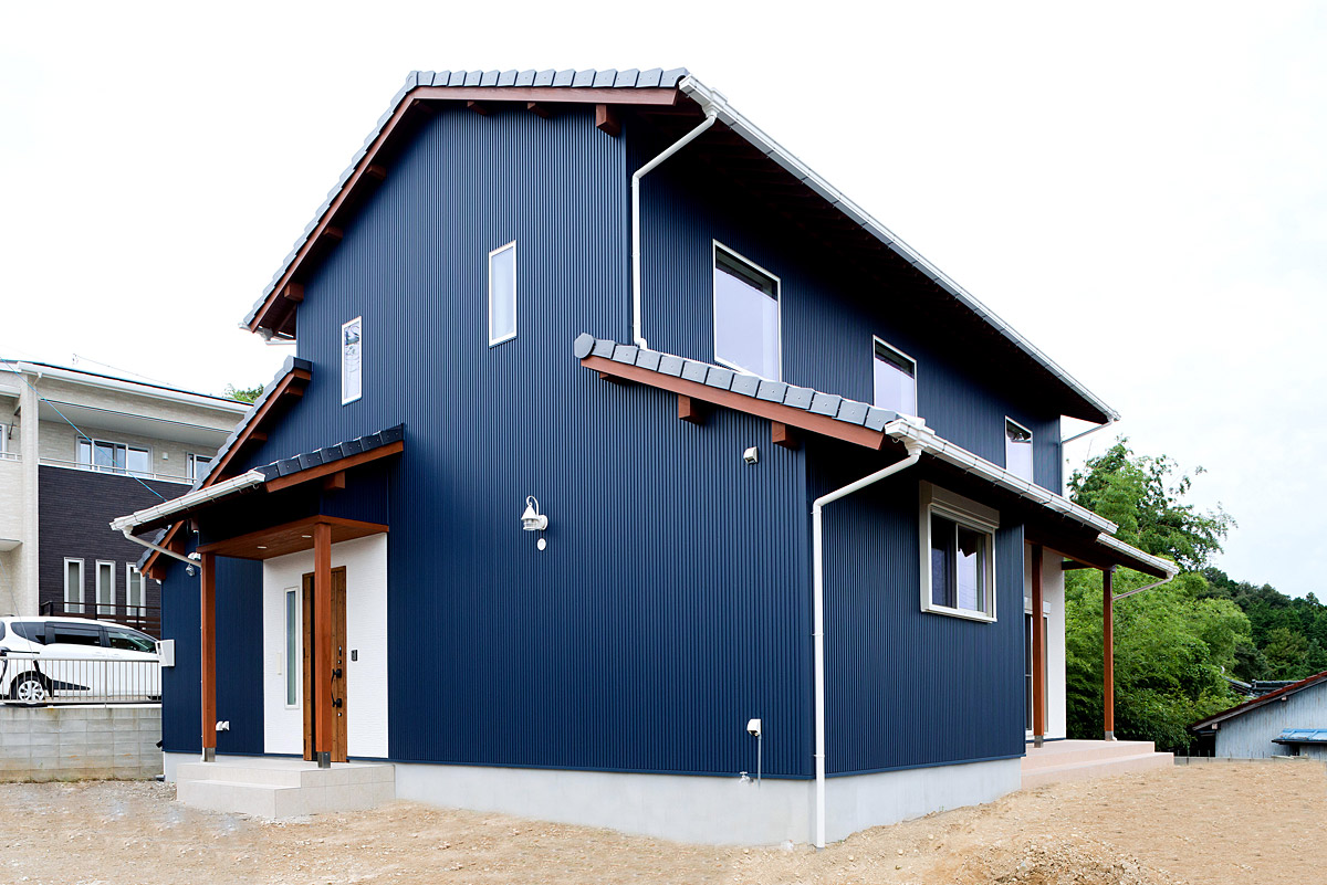 和モダンなデザインが魅力の濃紺ガルバリウム外壁の二階建て住宅外観